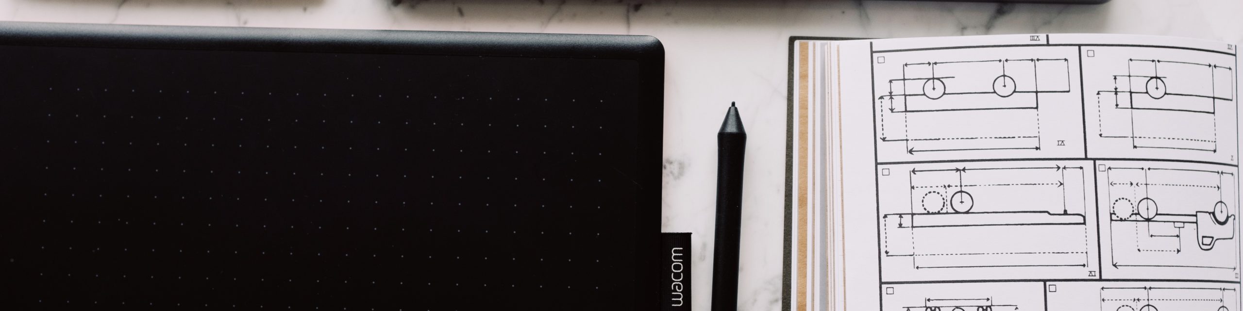technical-plan-drawn-on-paper-located-near-tablet-and-laptop-cropped